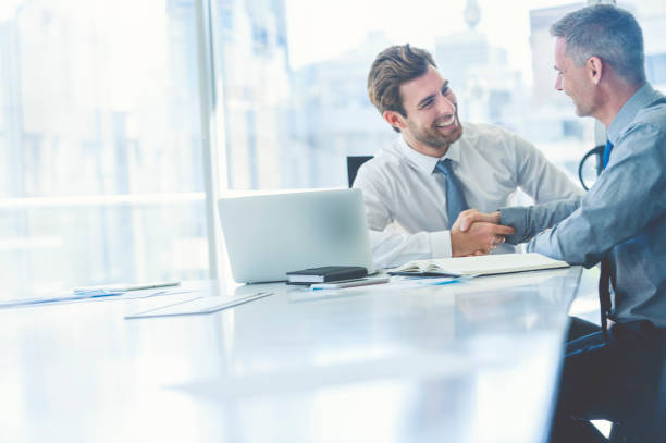 Two businessmen meeting with technology.