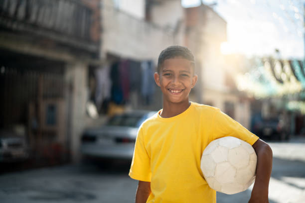 istock Brazilian Kid Playing Soccer Portrait 982137134