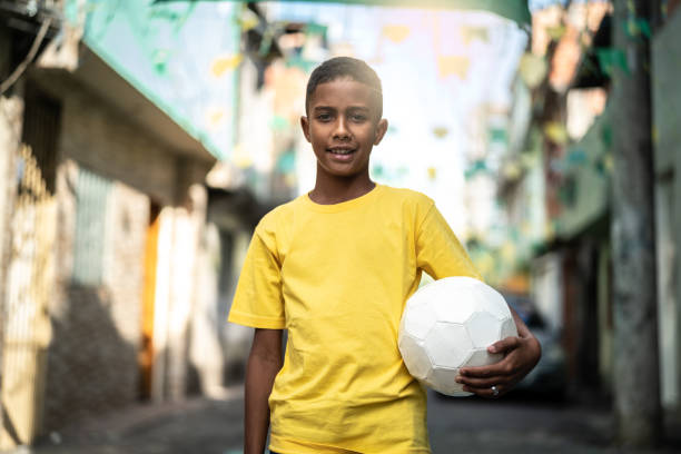 istock Brazilian Kid Playing Soccer Portrait 982137140