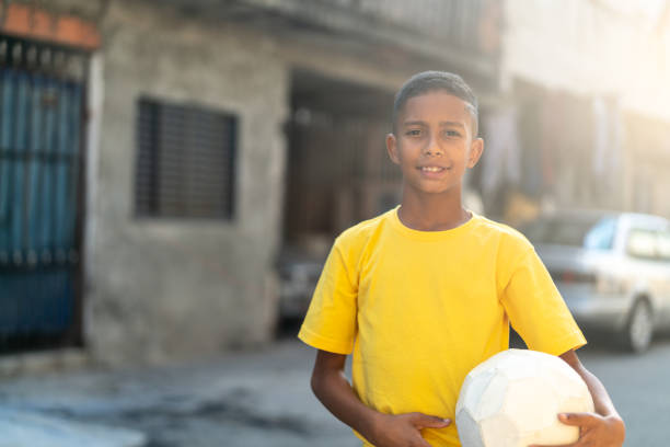 istock Brazilian Kid Playing Soccer Portrait 982142146