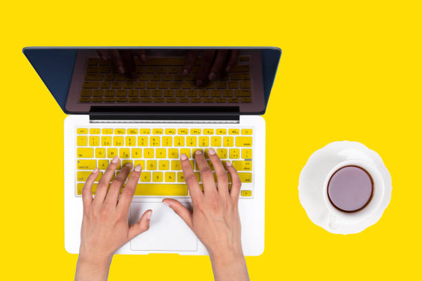 istock Yellow Keyboard Concept with woman hand 982155326