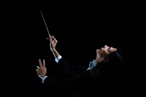 istock Woman in tuxedo conducting with baton 982189338