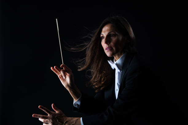 istock Woman in tuxedo conducting with baton 982189568