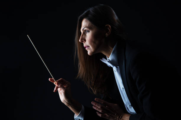 istock Woman in tuxedo conducting with baton 982189862