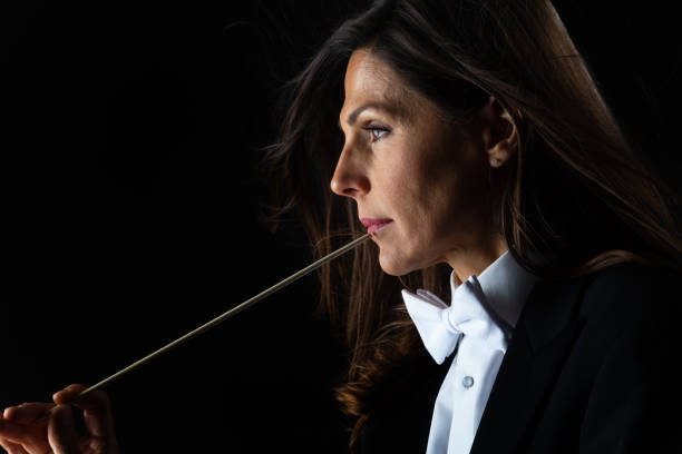 istock Woman in tuxedo conducting with baton 982189948