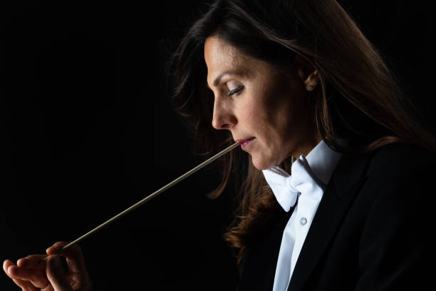 istock Woman in tuxedo conducting with baton 982192046