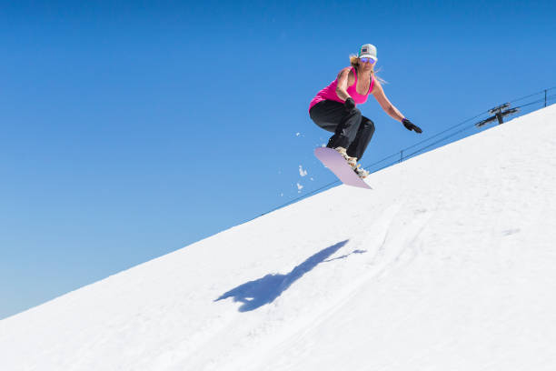 istock Adult Female Snowboarding 982206070