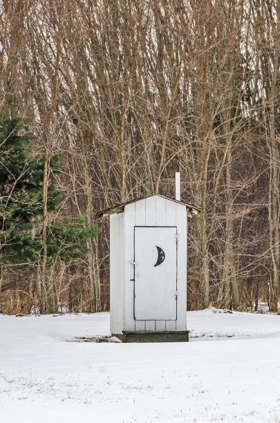 White Outhouse With a Crescent Moon