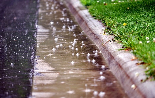 Close up of  water on the road, raindrops and air bubbles.