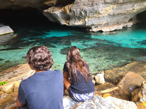 istock Two young adults contemplating a cave 982231822