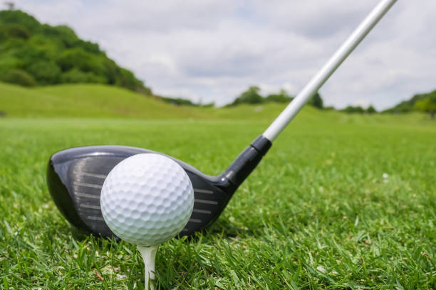 istock Golf Course where the turf is beautiful and Golf Ball on tee with driver golf club. Golf course with a rich green turf beautiful scenery. 982245446