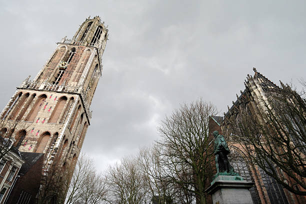 The Martinitoren and the Forum building under a dark sky in the historical city centre of Groningen.