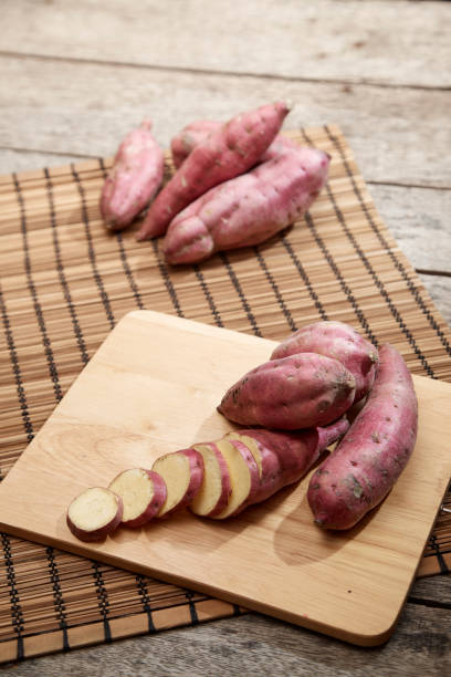 istock Raw sweet potato on wooden table 982257288