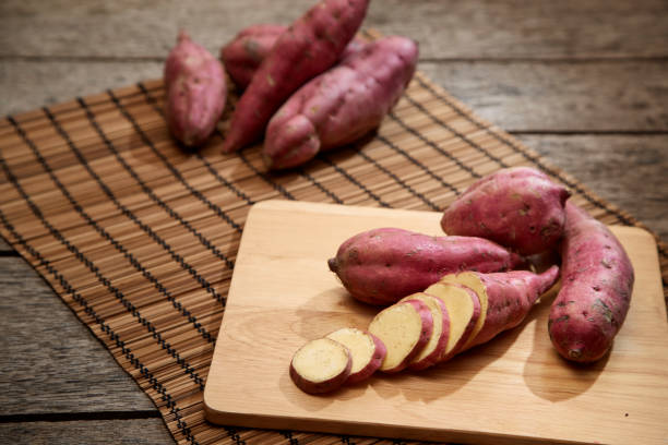 istock Raw sweet potato on wooden table 982257324