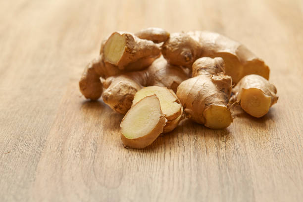 istock Ginger root sliced on wooden table 982257860