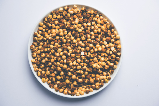 Roasted Chickpea / chana known as futana or Phutana in Hindi served in a bowl or over gunny bag. Selective focus