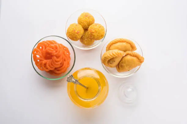Desi Ghee with Indian sweets like Gujiya, Motichoor laddu and imarti or Jalebi