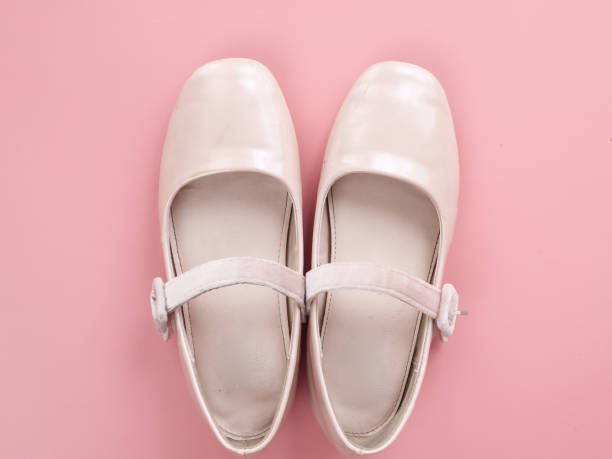 istock Pair of ballet shoes on pink background with copy space. 982301040
