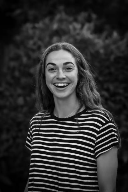 istock Young woman laughs in black and white 982304728