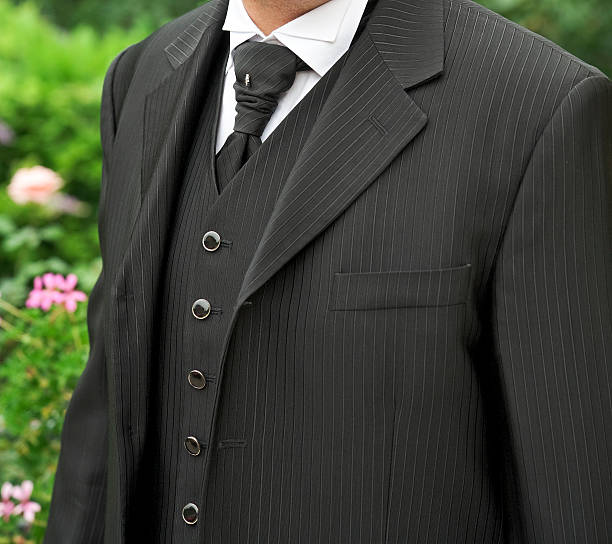 Businessman buttoning up suit jacket in preparation for meeting