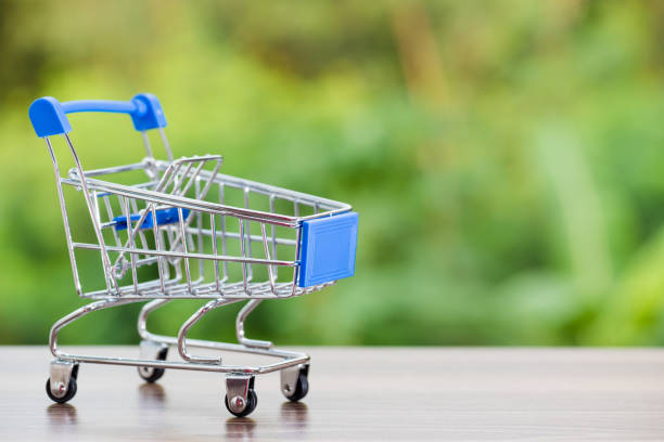 istock close up of Cart on keyboard computer with tablet background (Online shopping) 982310010