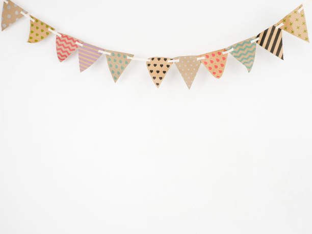 istock Triangle papers hanging on the rope.On the white wall with copy space. 982310154