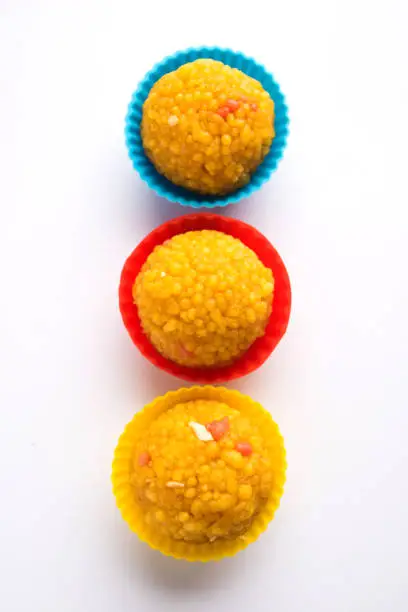Indian Sweet Motichoor laddoo Also Know as Bundi Laddu or Motichur Laddoo, served in colourful small cups. Selective focus