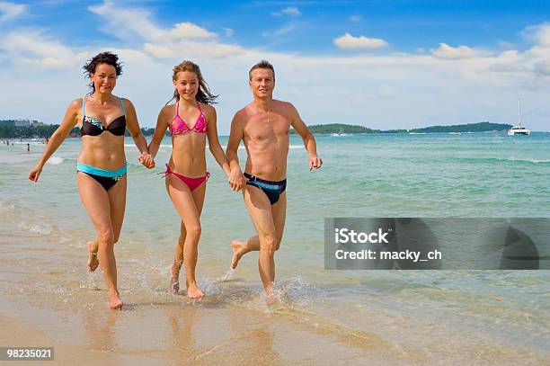 Family Running At The Beach Stock Photo - Download Image Now - Adult, Beach, Beautiful People