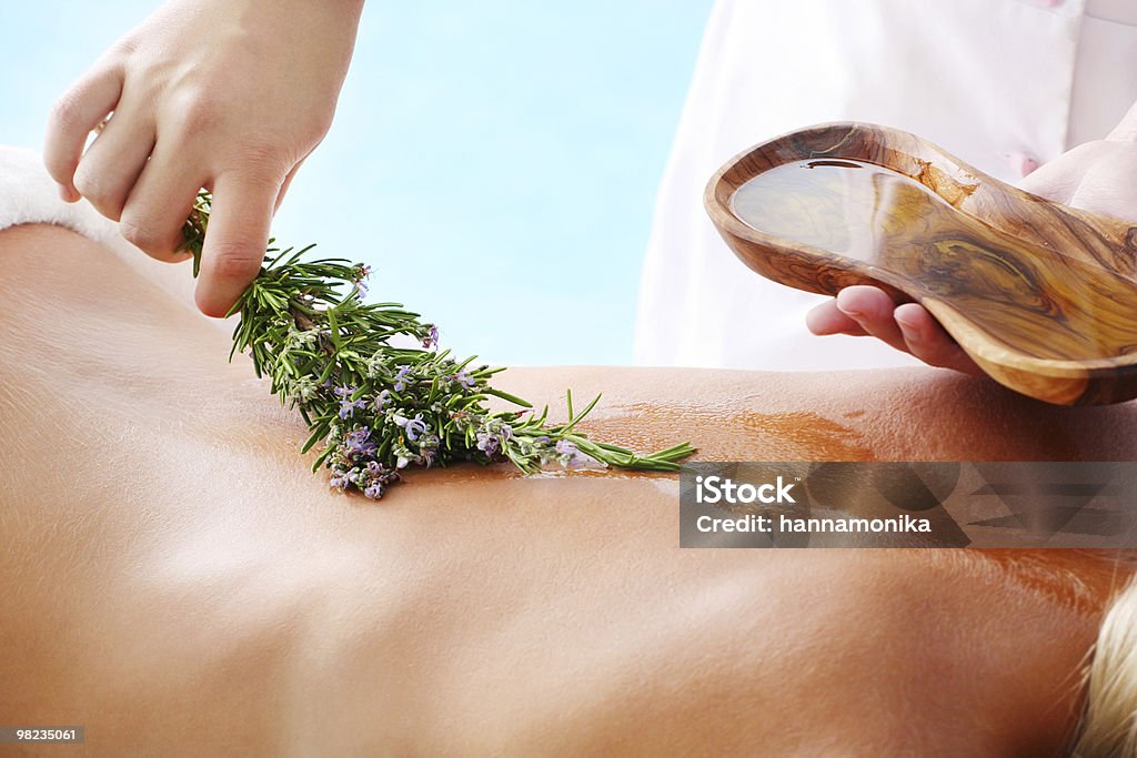 A woman having an organic beauty treatment Young woman undergoing a beauty treatment with olive oil and herbs. Adult Stock Photo