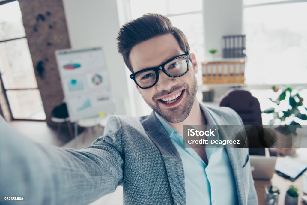 Self Portrait Of Joyful Funny Man In Shirt And Jacket Making Selfie On Smart  Phone With Hand Standing In Workplace Stock Photo - Download Image Now -  iStock