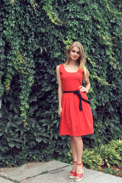 istock Blonde in bright red dress 982359136