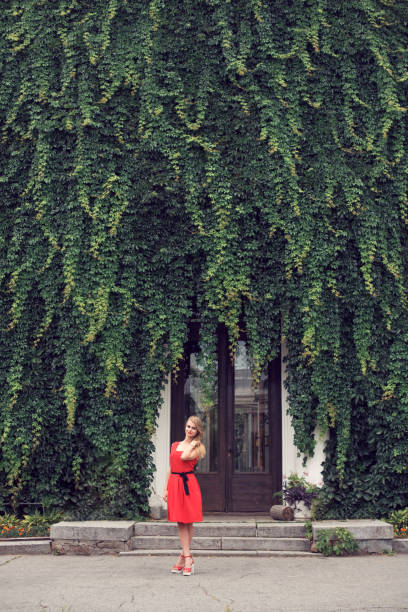 istock Blonde in bright red dress 982359196
