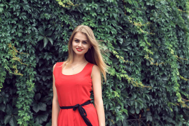 istock Blonde in bright red dress 982359208