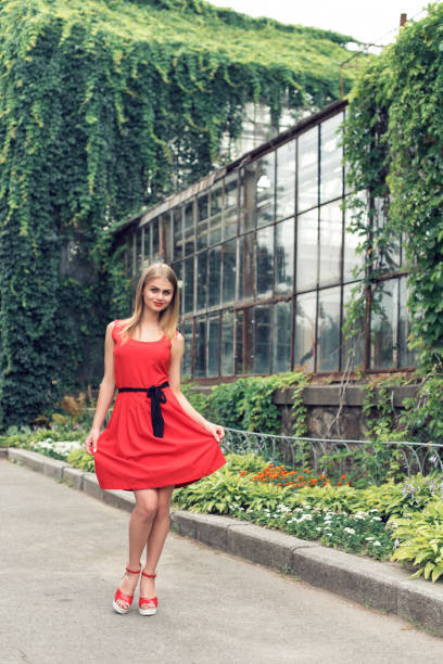 istock Blonde in bright red dress 982359486