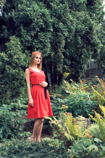 istock Blonde in bright red dress 982360200