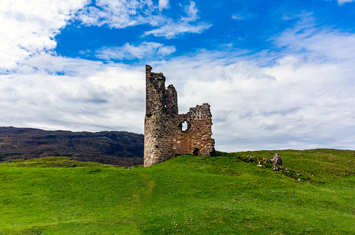 Craster, United Kingdom- July 12, 2023: Photograph of Dunstanburgh Castle on the North Sea coast of Northumberland, England. The castle was build in the 14th Century.