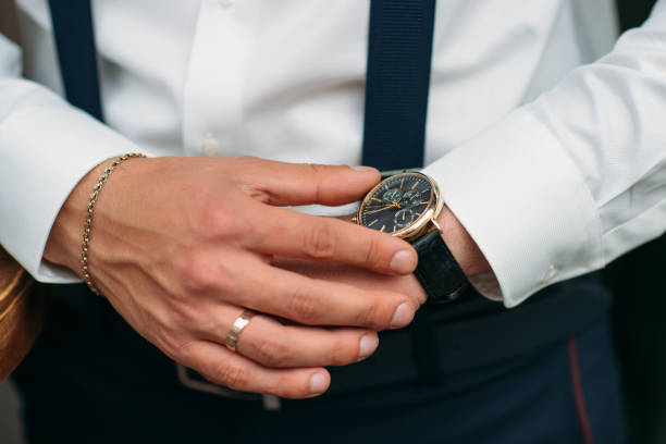 istock The groom walks through a beautiful park where trees are blooming 982363292