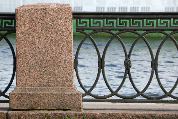 istock cast-iron fence on a granite embankment 982364122