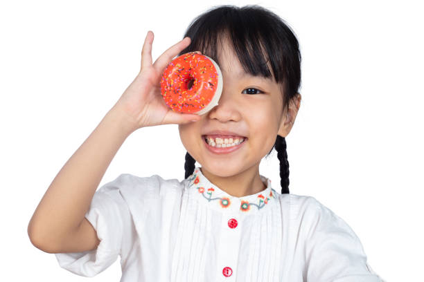 istock Asian Little Chinese Girl holding Donuts 982364236