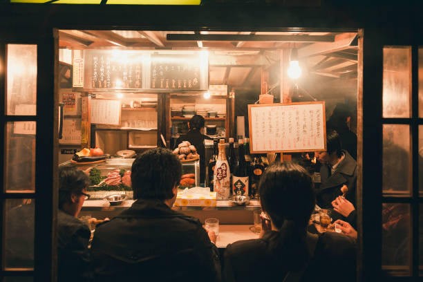 Yatai Fukuoka's food stands crowd people city nightlife FUKUOKA, JAPAN - MAR 3, 2012 : Yatai Fukuoka's open air food stands food stall Street food with crowd people city nightlife fukuoka city photos stock pictures, royalty-free photos & images