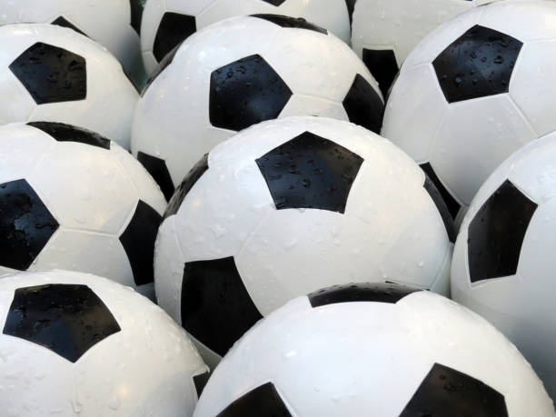 istock Soccer balls with water drops 982368680