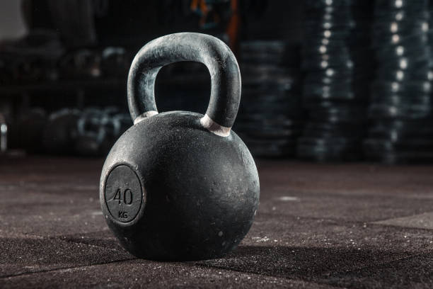Kettlebell training in gym Kettlebell training in gym kettlebell stock pictures, royalty-free photos & images