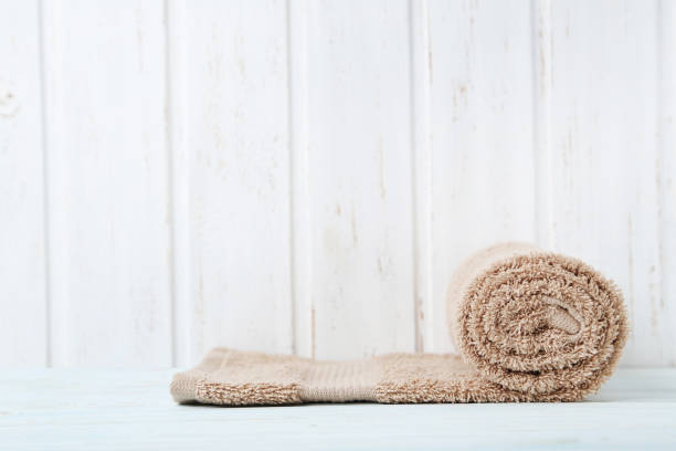 istock Towel on white wooden wall paneling background 982374926