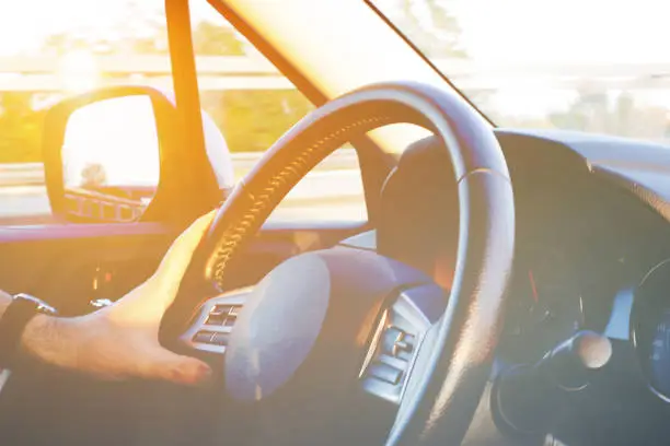 Abstract soft focus of person driving car, image of people driving car for background usage take photo from inside, vintage filter background.