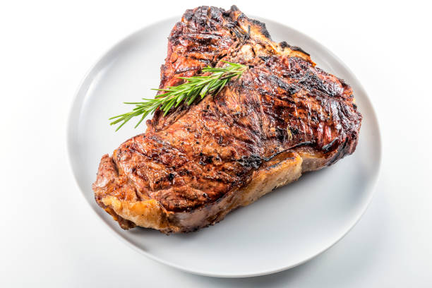 istock White round plate with Whole grilled T-bone steak and rosemary 982378826