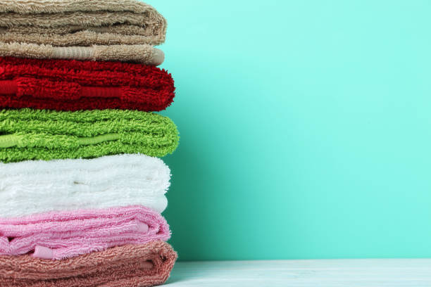istock Colorful towels on green background 982379364