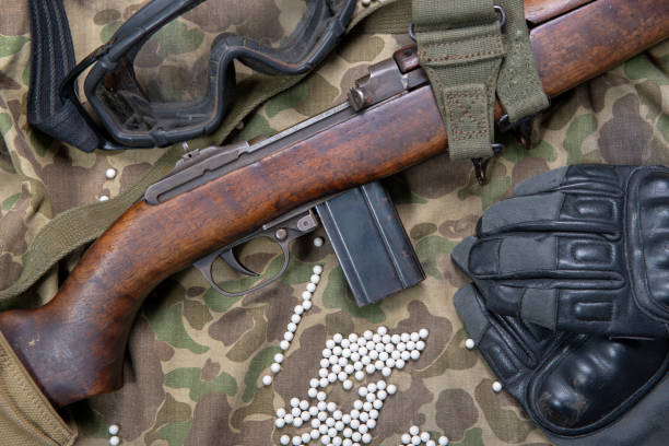 istock a airsoft rifle with protective glasses, gloves and white bullets 982382798