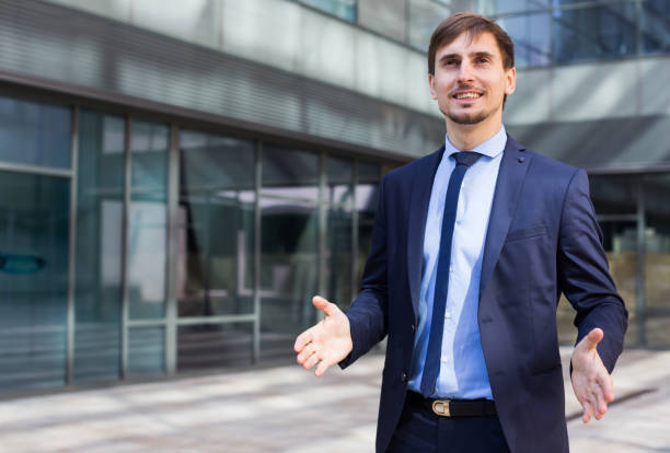 istock Smiling businessman standing outdoors 982389198