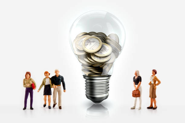 Miniature people in front a light bulb with Euro coins inside Miniature people in front a light bulb with Euro coins inside isolated on white figurine stock pictures, royalty-free photos & images