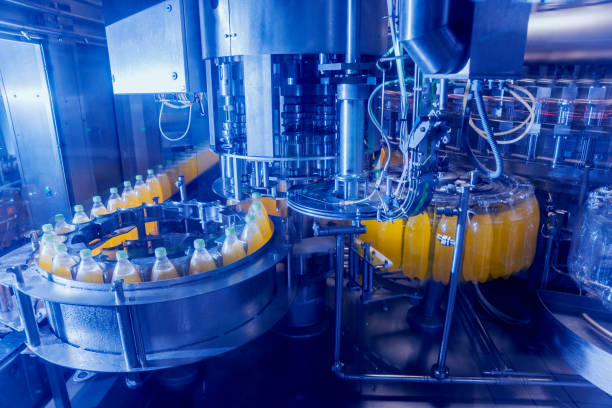 istock Automatic filling machine pours water into plastic PET bottles. Brewing production. 982397002